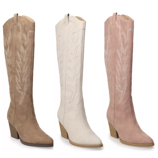 Three suede cowboy boots in brown, white, and pink, featuring embroidered designs and mid-height block heels.