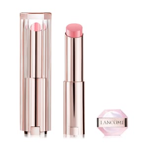 A Lancôme lipstick with a metallic pink tube and a matching cap on the side, showcasing a light pink shade.