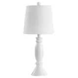 A white table lamp with a curvy, sculpted base and a round, tapered lampshade.