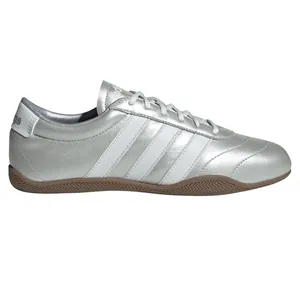 A silver Adidas Samba sneaker featuring white stripes and a gum sole.