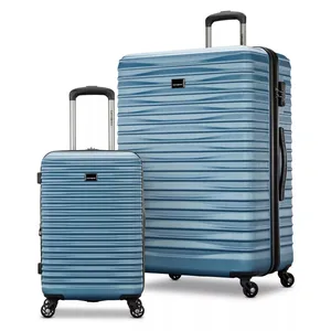 Two blue hard-shell suitcases with textured design, featuring retractable handles and four wheels for easy mobility.