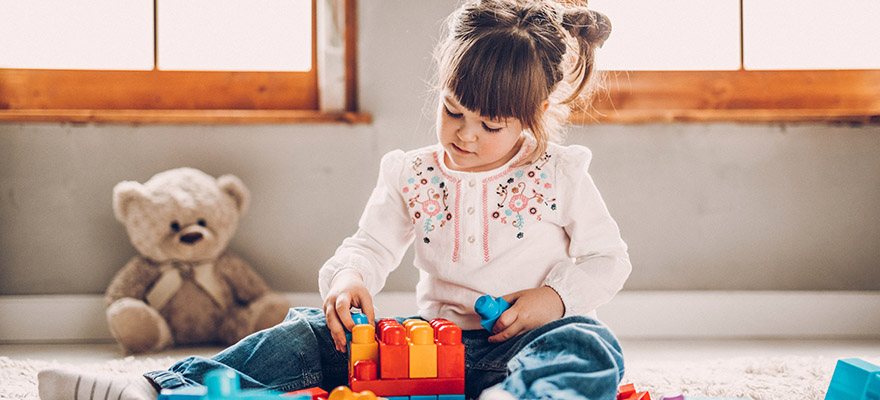 girl playing with toys from holiday toy catalogs