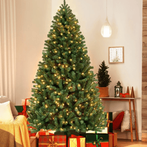 A 9-foot pre-lit artificial Christmas tree is adorned with warm white lights. It stands in a cozy room surrounded by wrapped gifts, creating a festive holiday atmosphere.