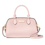 A pink dome-shaped handbag with a textured finish, dual top handles, and a detachable shoulder strap, featuring gold-tone hardware and a logo plaque on the front.
