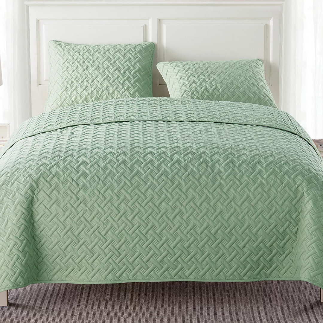 3-piece queen quilt set in a soft green color with a textured, geometric pattern, includes a quilt and two matching pillow shams.