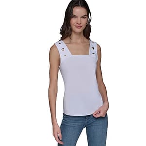 Sleeveless white square-neck top with grommet details on the straps, paired with blue jeans.
