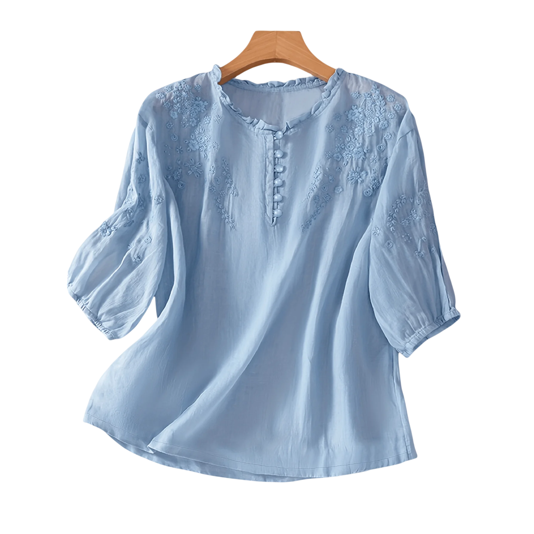 Light blue blouse with floral embroidery, featuring button accents and three-quarter sleeves.