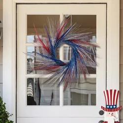 A red, white, and blue tinsel wreath is displayed on a white door, accompanied by a wooden Uncle Sam figure.