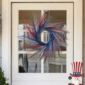 A red, white, and blue tinsel wreath is displayed on a white door, accompanied by a wooden Uncle Sam figure.