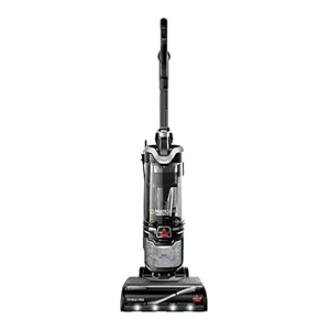 A black upright vacuum cleaner with a clear dust canister and handle, featuring the Bissell brand logo and designed for efficient floor cleaning.