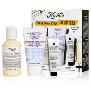 A Kiehl's skincare set featuring Creme de Corps body moisturizer, Ultimate Strength Hand Salve, and Lip Balm #1.