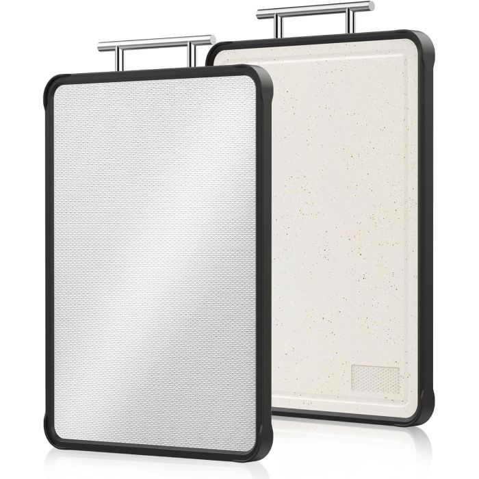 Two double-sided cutting boards with a black rubber edge and metal handles, featuring one smooth white speckled side and one textured surface for non-slip chopping.