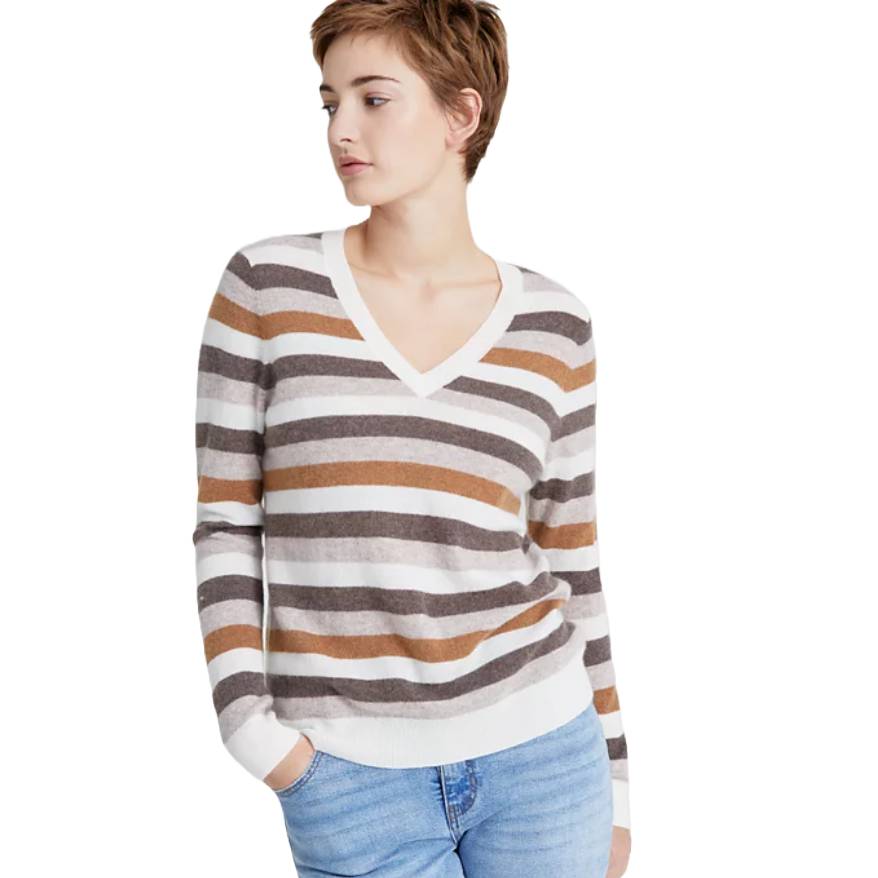 A person is wearing a striped V-neck sweater with beige, brown, and gray tones, paired with light blue jeans.