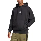 Man wearing a black hoodie with a small logo on the front, paired with olive green sweatpants featuring a similar logo.