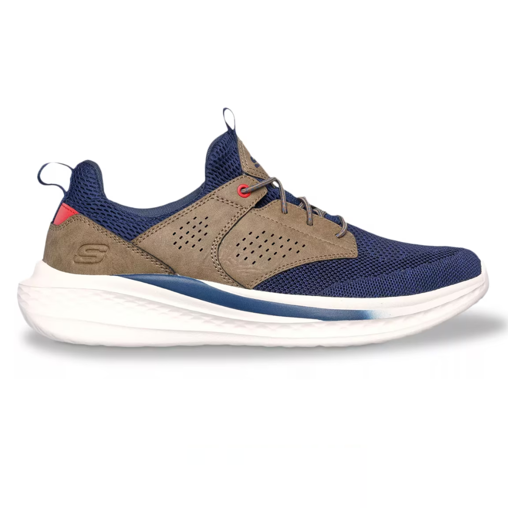 A sneaker with navy mesh fabric, tan suede overlays, and white foam sole. It features a low-cut design, lace-up closure, and branding on the heel counter.