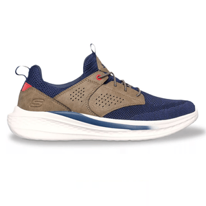 A sneaker with navy mesh fabric, tan suede overlays, and white foam sole. It features a low-cut design, lace-up closure, and branding on the heel counter.