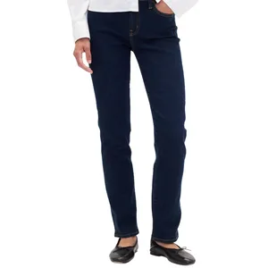 Dark blue straight-leg jeans paired with black ballet flats and a white blouse.