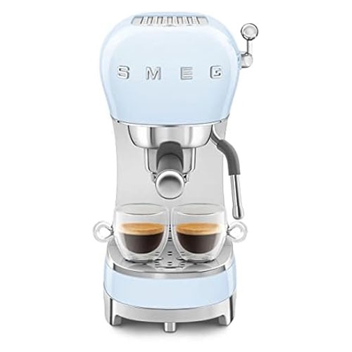 A light blue retro-style Smeg espresso coffee machine with dual espresso cups on the tray, featuring a steam wand on the side.