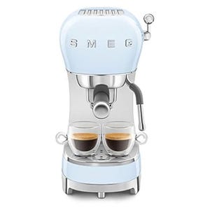 A light blue retro-style Smeg espresso coffee machine with dual espresso cups on the tray, featuring a steam wand on the side.