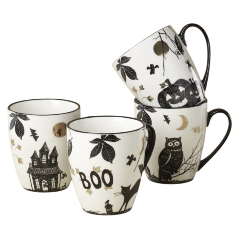 Four Halloween-themed mugs with black and white designs include images of a haunted house, \“Boo\“ text, black cat, leaves, owl, pumpkin, and bats.