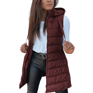 A woman is wearing a maroon quilted vest with a hood, over a white long-sleeve top and black leather-look pants, accessorized with a belt featuring a round buckle.