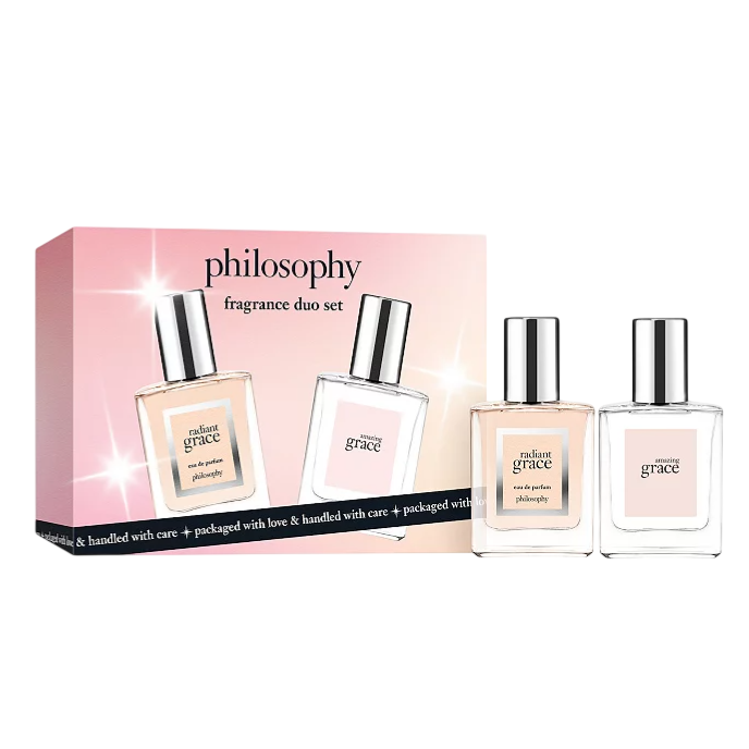 Philosophy fragrance duo set includes \“radiant grace\“ and \“amazing grace\“ eau de parfum, packaged in a pink box with the brand's name.
