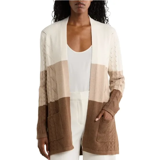 Color-blocked cardigan with cable knit details, featuring shades of cream, beige, and brown, and front pockets.