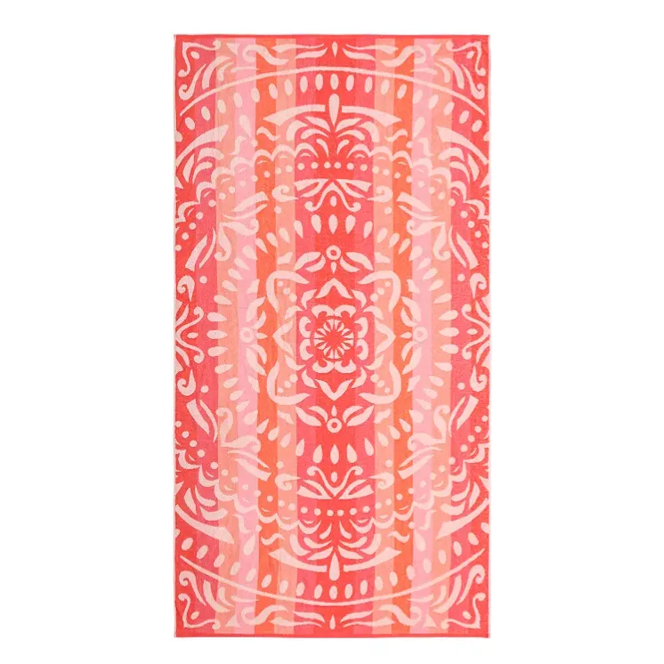 A pink and orange patterned towel featuring a symmetrical, ornate design with floral and abstract elements.