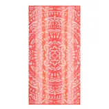 A pink and orange patterned towel featuring a symmetrical, ornate design with floral and abstract elements.