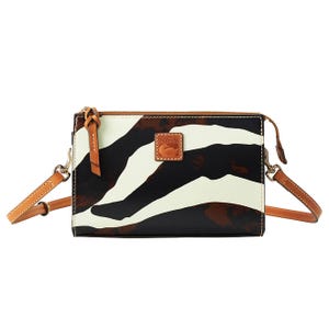 A small crossbody bag with a zebra-like abstract pattern in black, white, and brown, featuring a tan leather strap and a stitched logo patch.