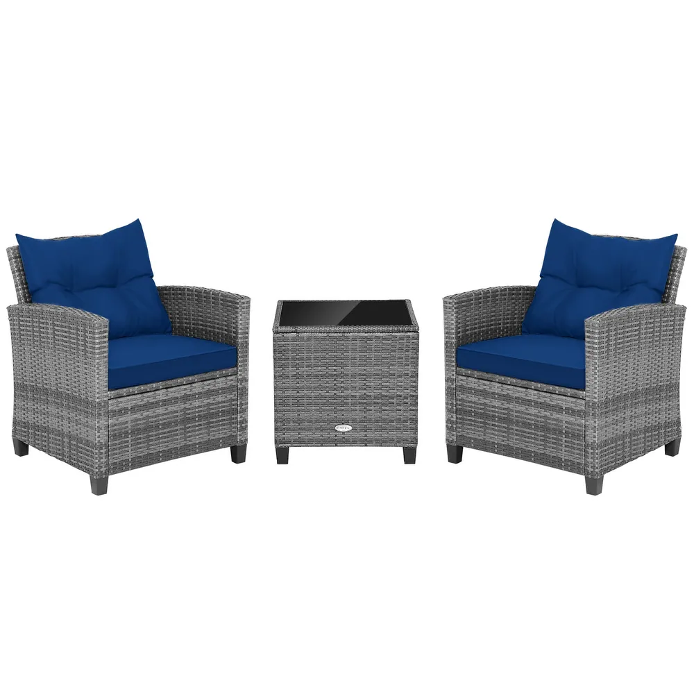 Grey wicker patio furniture set with two armchairs featuring blue cushions and a square table with a glass top.