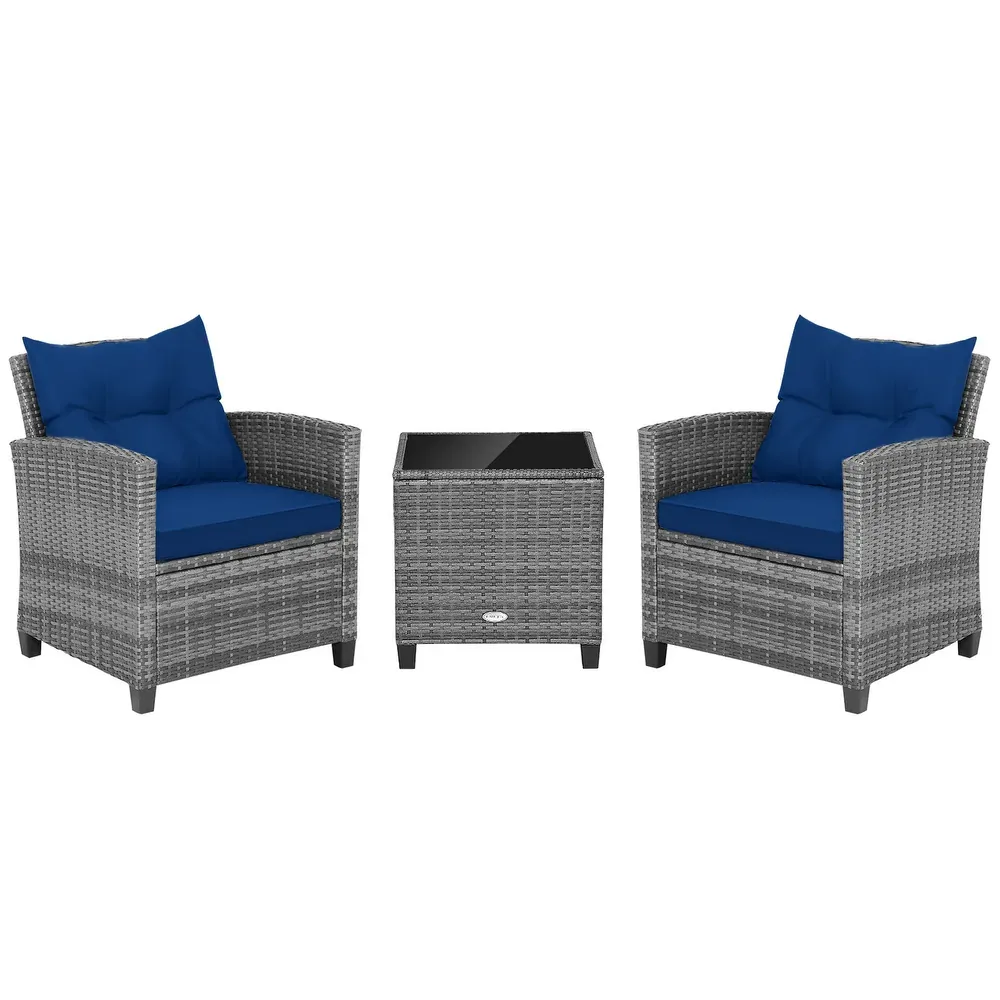 Grey wicker patio furniture set with two armchairs featuring blue cushions and a square table with a glass top.