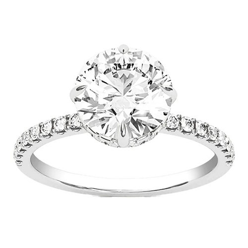 A 3-carat lab-grown diamond ring set in a white gold band, featuring a round brilliant-cut center stone with a halo of smaller diamonds adorning the ring's band.