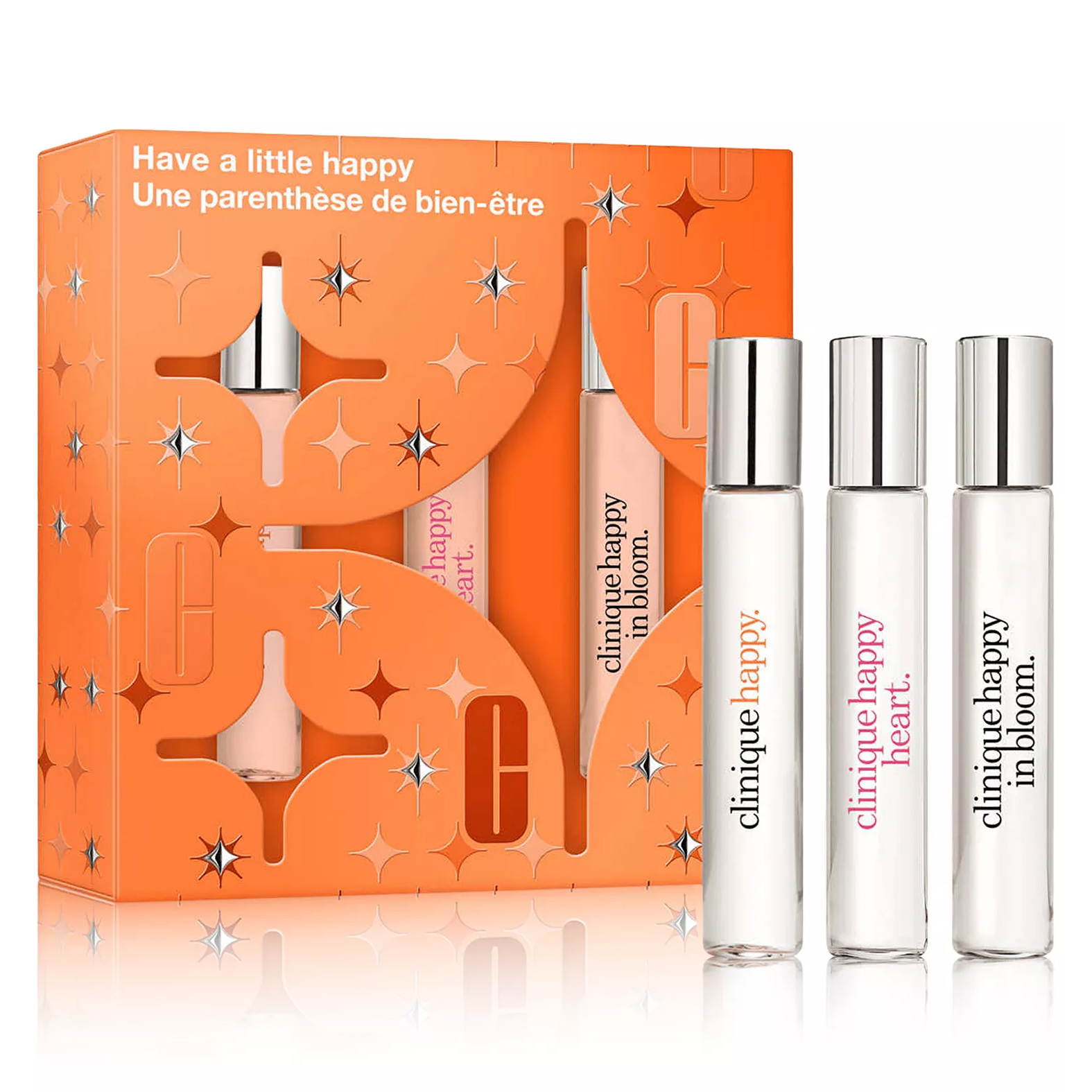 Three Clinique perfumes are shown: \“Happy,\“ \“Happy Heart,\“ and \“Happy in Bloom,\“ in a gift set with an orange decorative box.