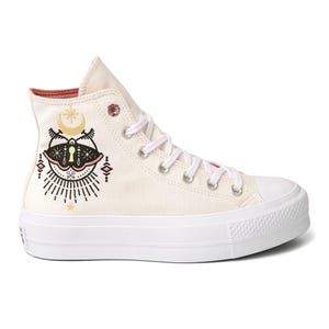Converse Women's Boho High-Top Sneaker features a cream canvas with a mystical design, including crescent moon and cat motifs, white laces, and a rubber sole.