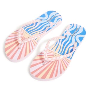 Vera Bradley Flip-Flops feature a vibrant design with pink and yellow sunburst patterns on the soles and blue wavy lines. They have pink flower-adorned straps and display a cheerful face graphic.