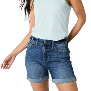 High-rise denim shorts with a classic blue wash, cuffed hems, and a button-zip closure, paired with side and back pockets.