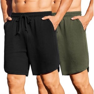 Two pairs of men's athletic shorts in black and olive green. Both have an elastic waistband with a drawstring and side pockets.