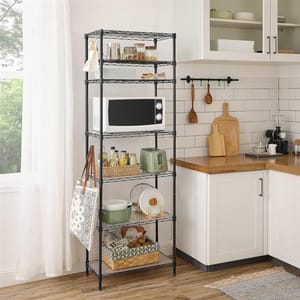 A black metal shelving unit with a microwave, toaster, dishes, and various kitchen items.