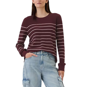 A maroon crewneck sweater with white horizontal stripes, paired with light blue cargo jeans. The sweater has long sleeves and a relaxed fit, creating a casual and comfortable look.