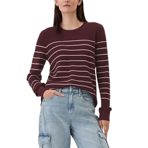 A maroon crewneck sweater with white horizontal stripes, paired with light blue cargo jeans. The sweater has long sleeves and a relaxed fit, creating a casual and comfortable look.