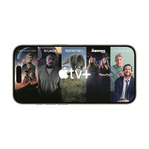 A smartphone screen displays Apple TV+ content, featuring posters for \“Foundation,\“ \“Hijack,\“ \“Prehistoric Planet 2,\“ \“The Morning Show,\“ and \“Shrinking.\“