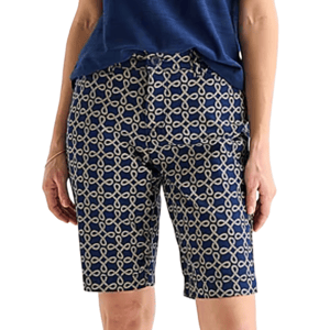 A person wearing blue shorts with a beige chain-link pattern, paired with a tucked-in blue shirt.