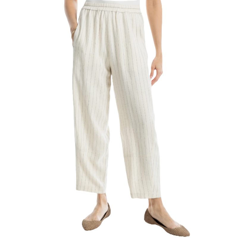 White linen blend pants with subtle vertical pinstripes, featuring an elastic waistband and a relaxed, tapered fit. Paired with brown woven flats.