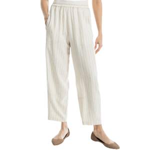 White linen blend pants with subtle vertical pinstripes, featuring an elastic waistband and a relaxed, tapered fit. Paired with brown woven flats.