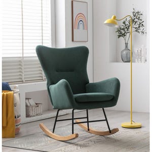 Green upholstered rocking chair with high backrest and armrests, set on black metal legs with wooden rockers.
