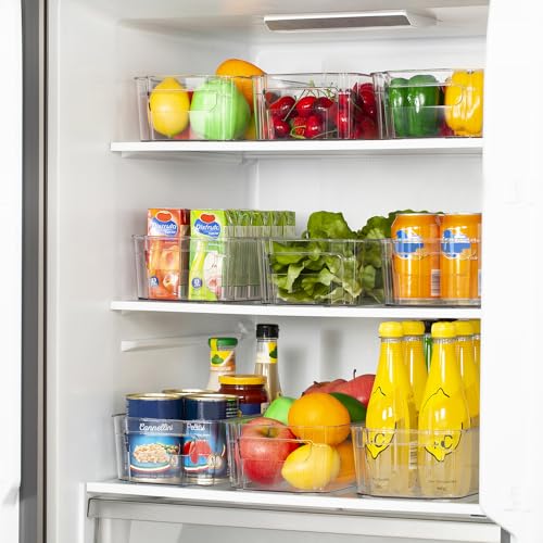 Clear storage bins with handles are arranged in a refrigerator holding fruits, vegetables, beverages, and other food items.