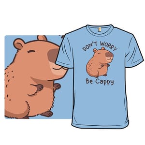 Light blue t-shirt featuring a cute capybara with the text \“Don't Worry, Be Cappy\“ in a playful font.