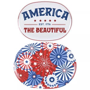 Two oval platters with a patriotic theme: one displaying \“AMERICA THE BEAUTIFUL EST. 1776\“ with stars, and the other featuring red, white, and blue starburst patterns.