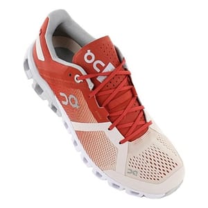 Red and white athletic running shoe with breathable mesh and cushioned sole.